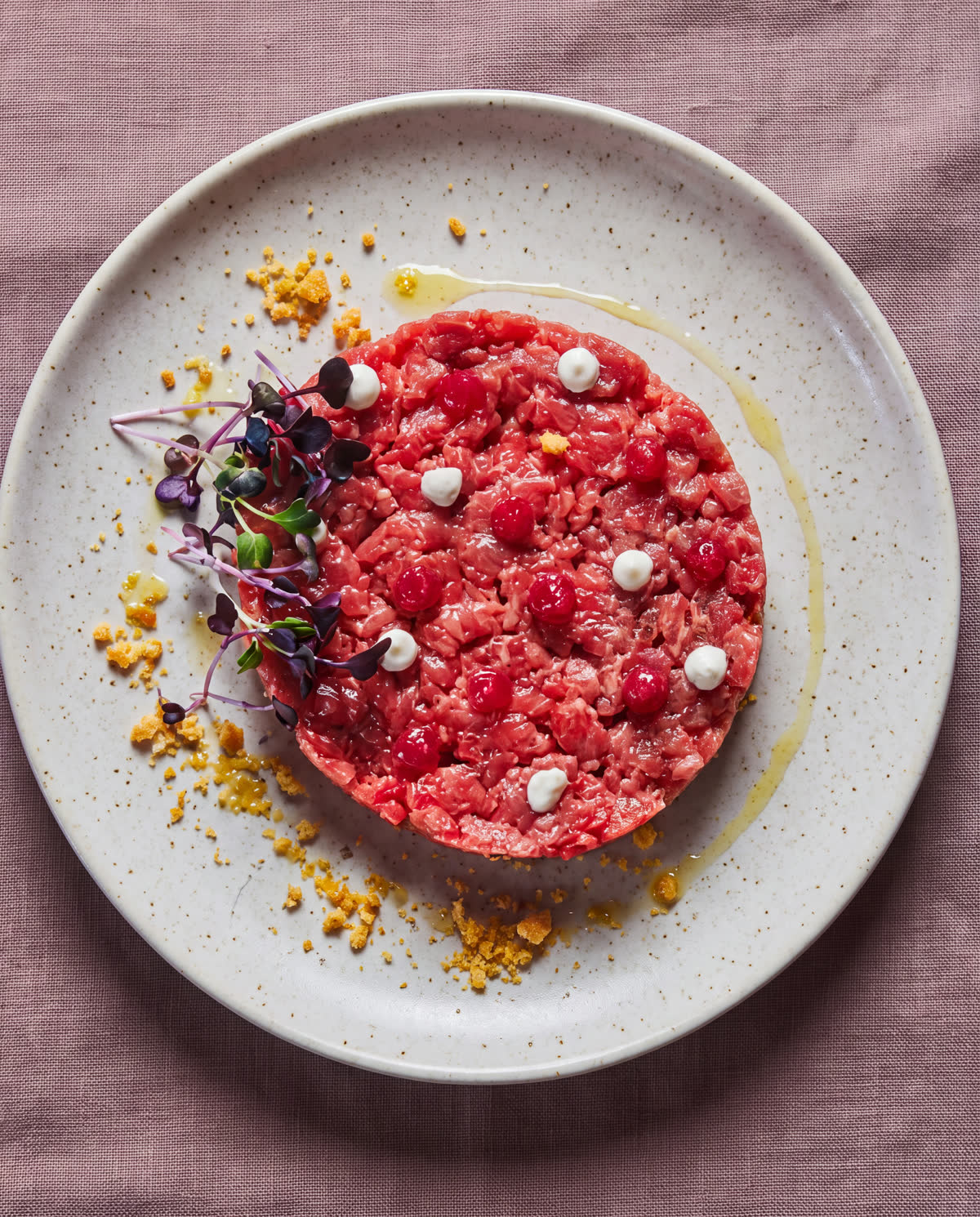 Tartare di manzo battuta al coltello, con perle di crema ed erbe fresche